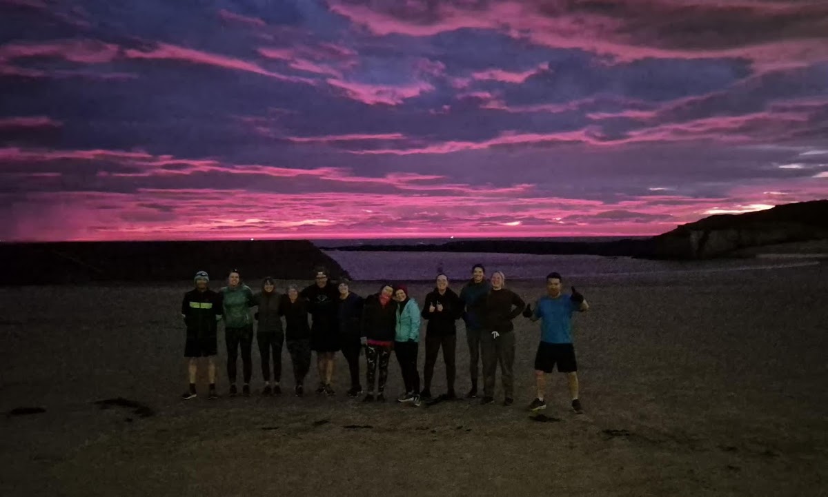 The bootcamp group in front of a dawn sky