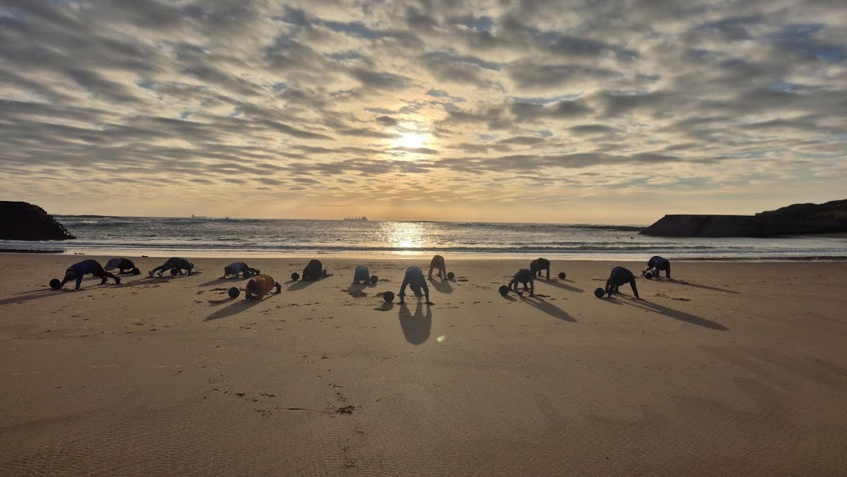 Bootcamp press-ups with the sun low over the sea