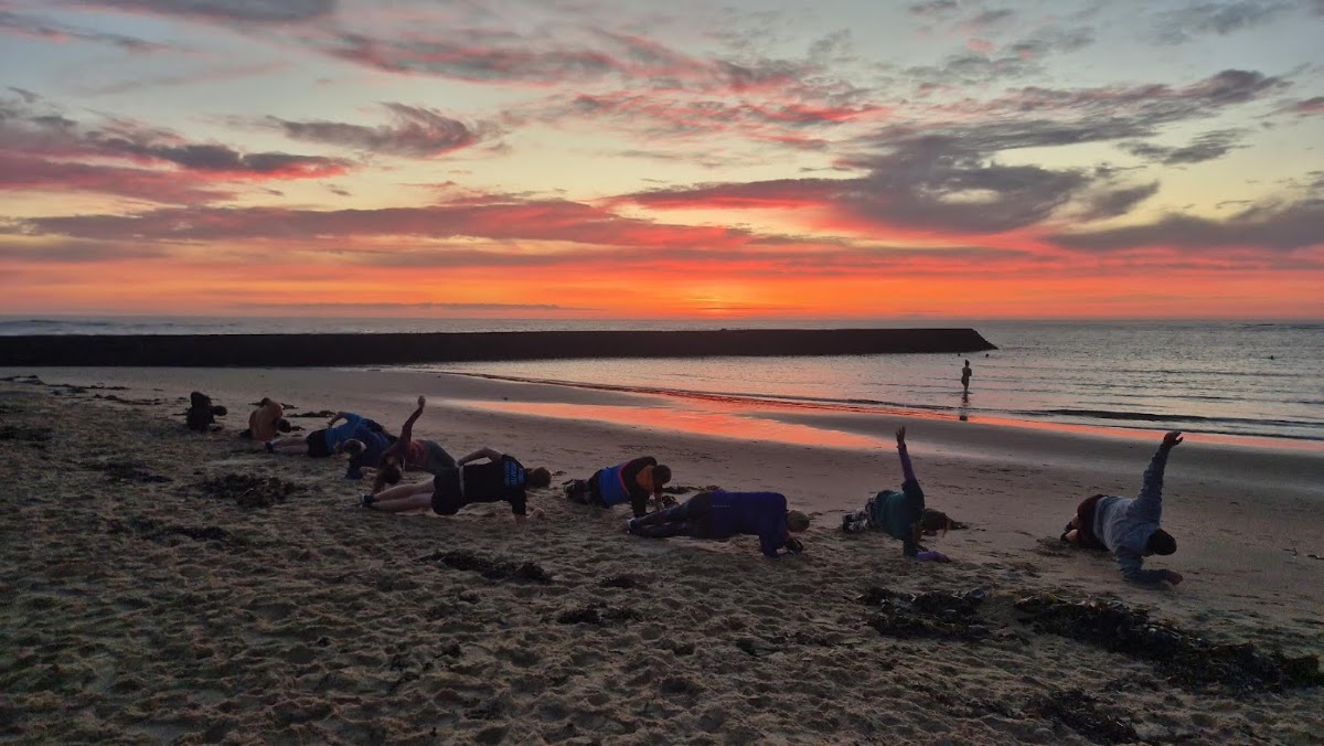 Core work on the sand under a red sunset